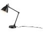 Lampe de bureau noire réglable avec base ronde et bras flexible, allumée.