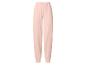 Pantalon de jogging femme rose clair avec taille élastique et chevilles resserrées.