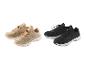 Deux paires de baskets, beige et noires, avec lacets.