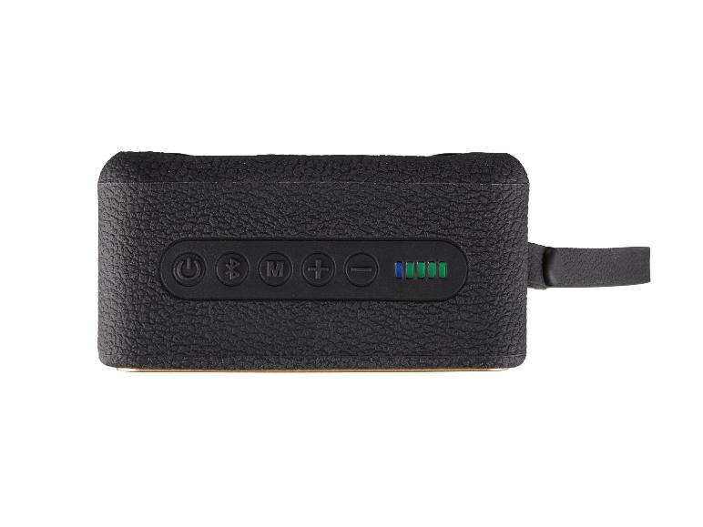 Enceinte portable noire avec boutons de commande et indicateur de batterie.
