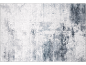 Tapis à motifs abstraits gris et blanc.