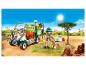 Véhicule vétérinaire Playmobil avec figurine, chien et singe dans un environnement de safari.
