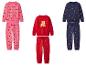 Trois ensembles de pyjamas de Noël pour enfants : rose avec des teckels, rouge avec des rennes et bleu marine avec des cannes à sucre.
