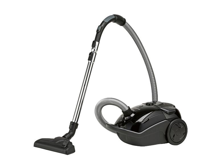 Aspirateur traîneau noir avec poignée et tuyau métalliques.