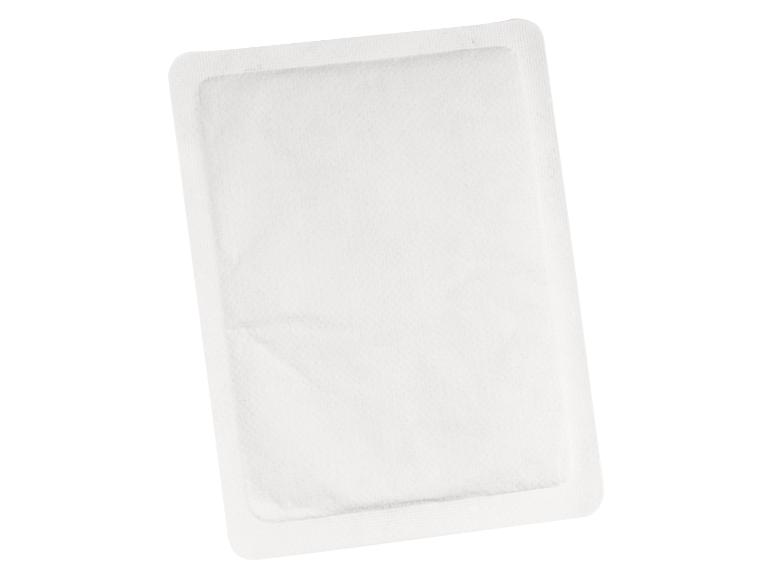 Un coussin chauffant blanc dans un emballage isolé.