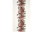 Chemin de table avec motif floral de Noël rouge et vert, avec grenades et houx.