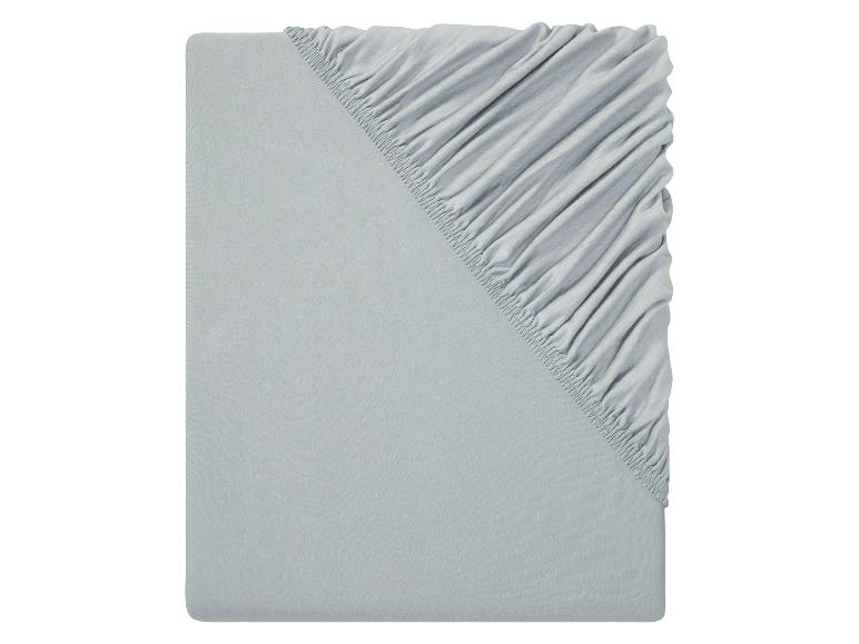 Drap-housse et drap plat gris clair.