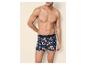 Homme torse nu en caleçon imprimé floral bleu et orange.