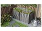 Jardinière surélevée en métal gris avec lavande et sauge dans un jardin.