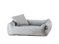 Un panier pour chien gris avec un coussin.