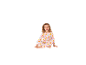 Petite fille en pyjama rose à motifs assise par terre