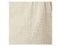 Détail d'un tissu crème, doux et texturé.