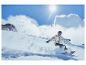 Un snowboarder descendant une pente par une journée ensoleillée.