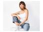 Femme en débardeur blanc, jean large et baskets blanches, assise.