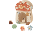 Jouet d'activités en bois en forme de maison champignon avec formes à trier : escargot, feuille, champignon et fleur.
