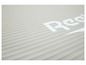 Un tapis de yoga Reebok gris avec une surface texturée.