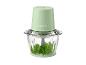 Hachoir électrique vert avec bol en verre rempli de persil.