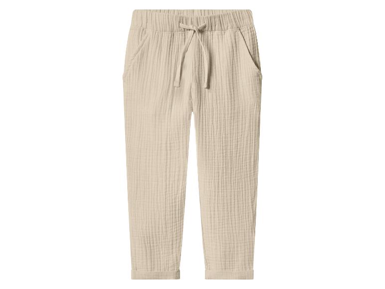 Pantalon long beige en mousseline avec taille élastique et cordon de serrage.