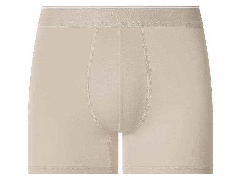 Caleçon boxer beige pour homme avec ceinture élastique.