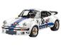 Voiture miniature Porsche 911 Martini Racing blanche avec des rayures bleues et rouges.
