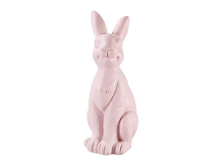 Lapin décoratif rose pâle en céramique, assis, pour Pâques.