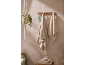 Serviettes claires suspendues à un porte-manteau en bois dans une salle de bain avec plante et radio.