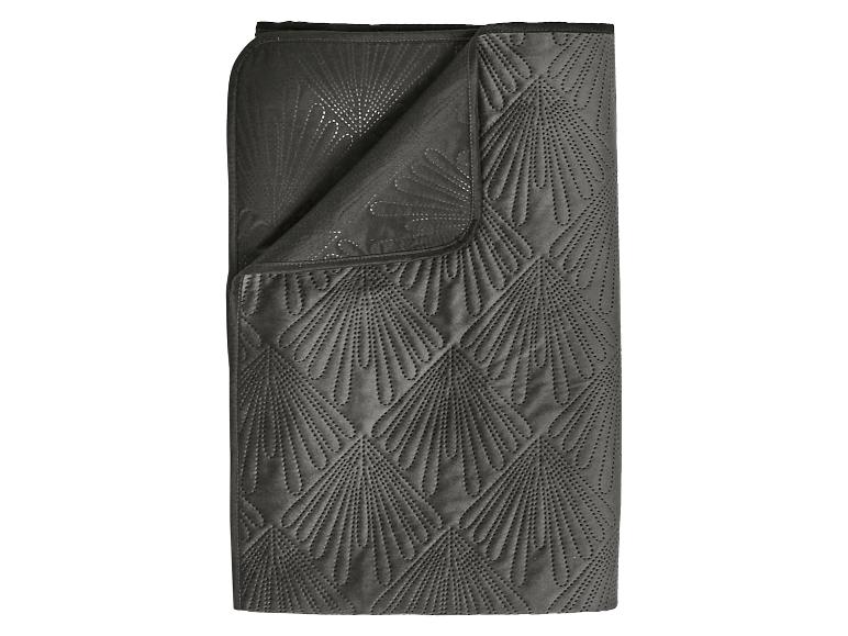 Couverture gris foncé avec un motif matelassé en éventail.
