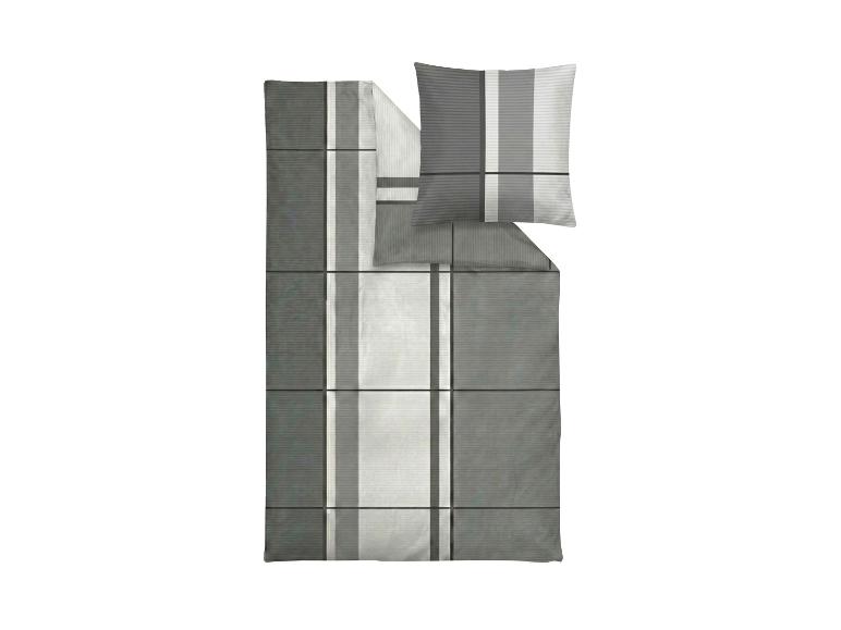 Parure de lit à carreaux gris et blancs avec oreiller.
