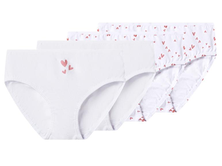 Quatre paires de culottes blanches pour enfants, deux avec de petits cœurs roses, deux unies avec trois cœurs roses.