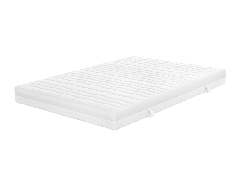 Un matelas blanc avec une texture ondulée.