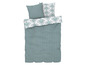 Une housse de couette avec un motif géométrique et des oreillers avec un motif soleil.