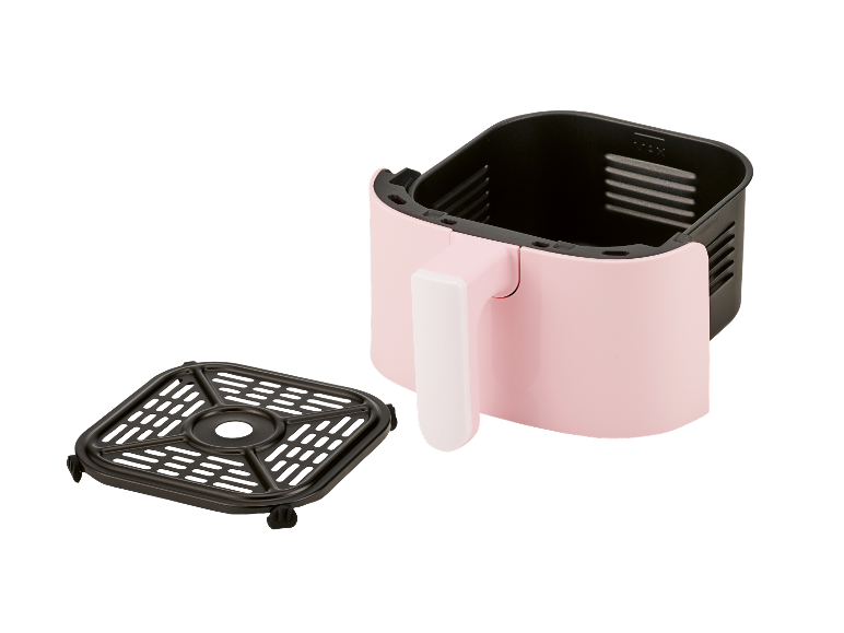 Une friteuse à air rose avec un panier amovible.