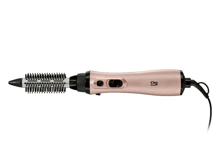 Brosse soufflante or rose avec poils noirs et cordon électrique