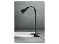 Une lampe de bureau noire avec pince fixée à une surface blanche.