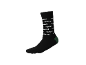 Chaussette mi-haute noire avec motif de texte blanc et talon vert.