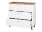 Commode blanche à trois tiroirs avec des pieds en bois.