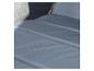 Gros plan d'un coussin gris sur une chaise longue.