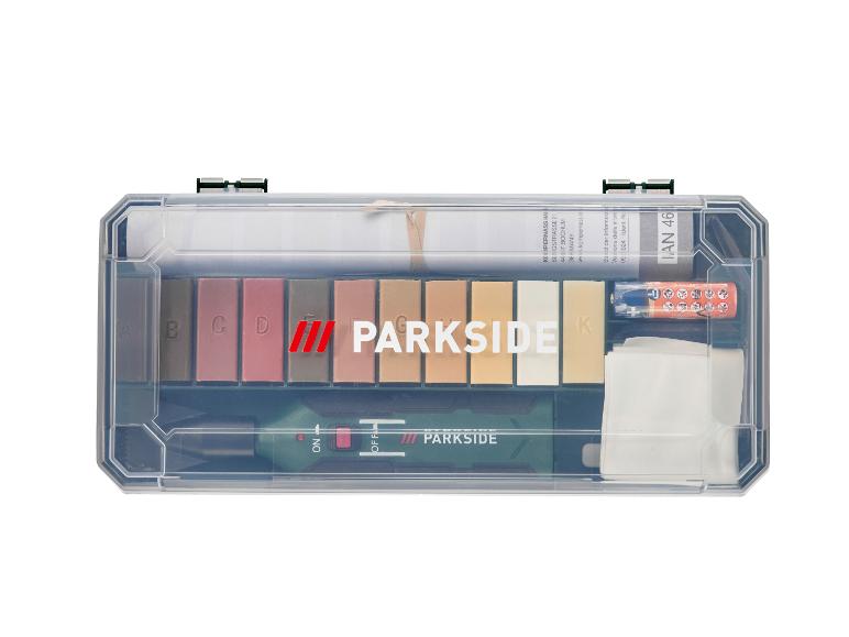 Kit de réparation PARKSIDE avec bâtonnets de cire, outil de fusion et accessoires dans une boîte transparente.