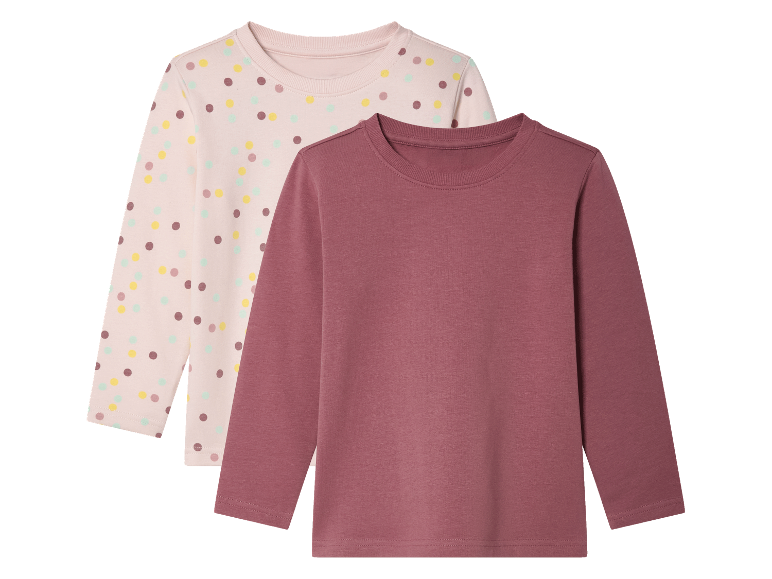 Deux t-shirts à manches longues pour filles : un rose à pois et un rose uni.
