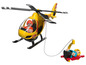 Un hélicoptère jouet jaune avec un canot de sauvetage suspendu à une corde.