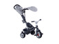 Un tricycle Smoby gris avec un pare-soleil.