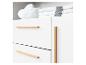 Commode blanche avec poignées en bois et un oreiller en forme de nuage avec de la literie.