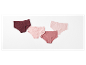 Trois culottes en coton rose et bordeaux.
