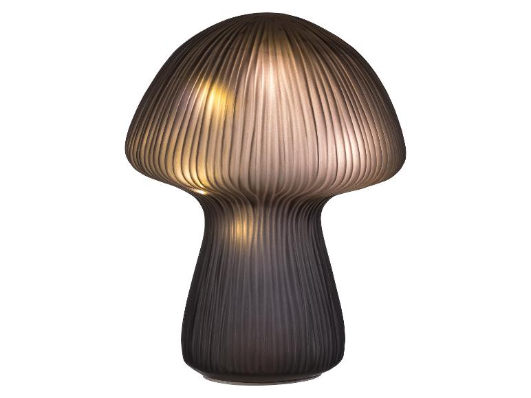 Lampe de table moderne en forme de champignon avec abat-jour nervuré et lumière chaude.