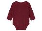 Un body bébé à manches longues de couleur bordeaux.