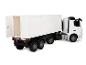 Camion jouet blanc avec une remorque blanche et des portes latérales ouvrantes.
