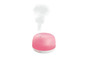 Un humidificateur rose avec de la vapeur.