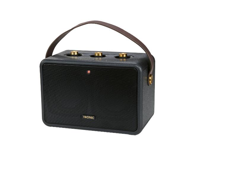Enceinte portable noire avec poignée marron et boutons dorés, avec le logo TRONIC.