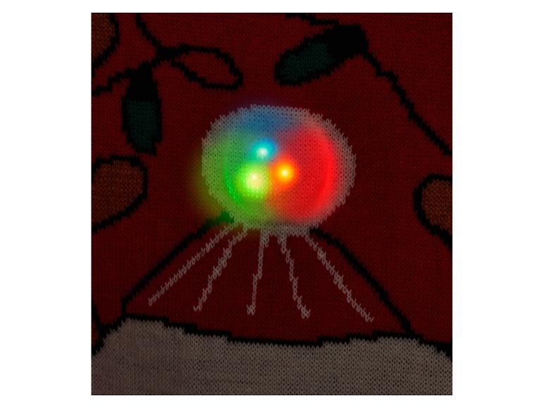 Gros plan d'un pull en tricot rouge avec un motif de soucoupe volante lumineuse.