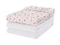 Pile de deux draps-housses blancs avec un drap-housse à motifs floraux sur le dessus